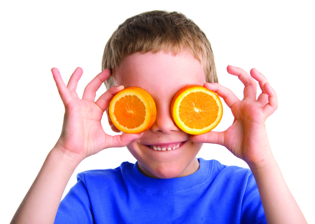 boy with an orange on white background