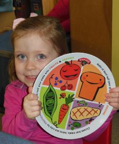 Lots of Tots Student Holding Hannaford MyPlate